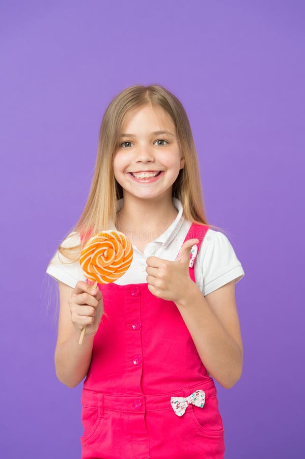 Girl Eating Colorful Lollipop. Sweet Childhood Concept. Kid with Long ...