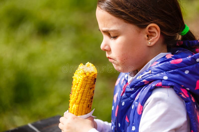 Girl Eating Corn in a Field Stock Photo Image of summer, cute 272079020
