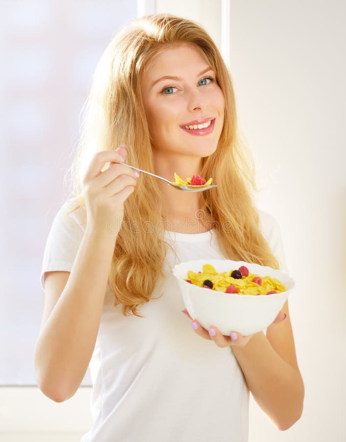 Girl eating corn flakes stock image. Image of flakes 82117895