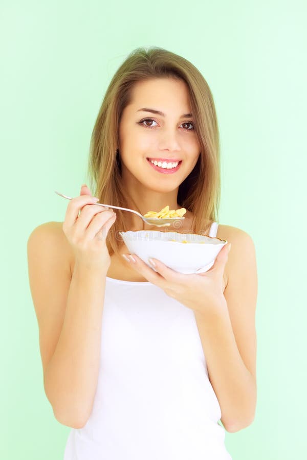 Girl eating cornflakes with