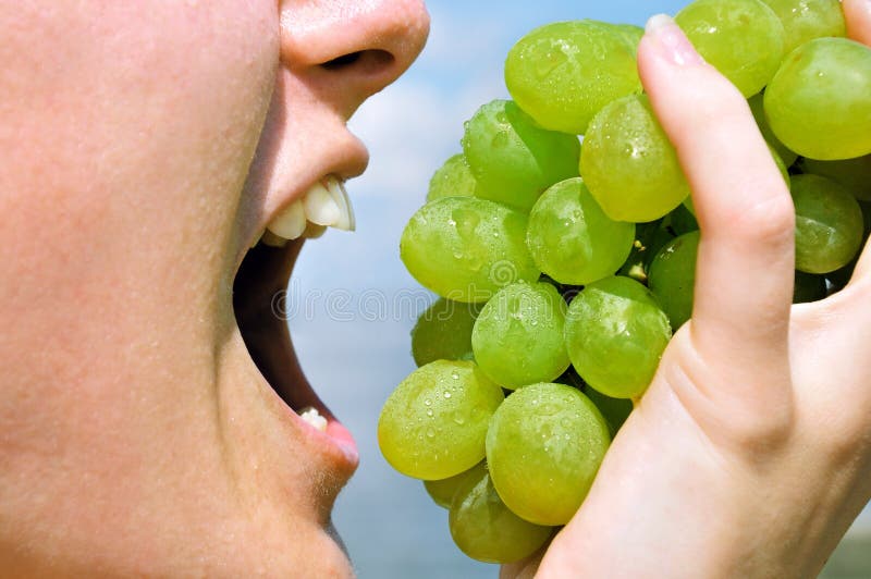 Girl eating grapes