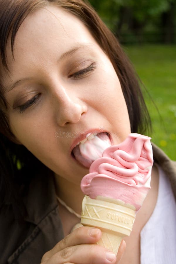 Girl eating an ice-cream outdoor