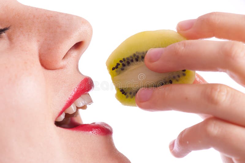 Girl eating a kiwi close up