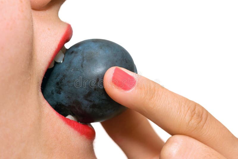 Girl eating plum close up