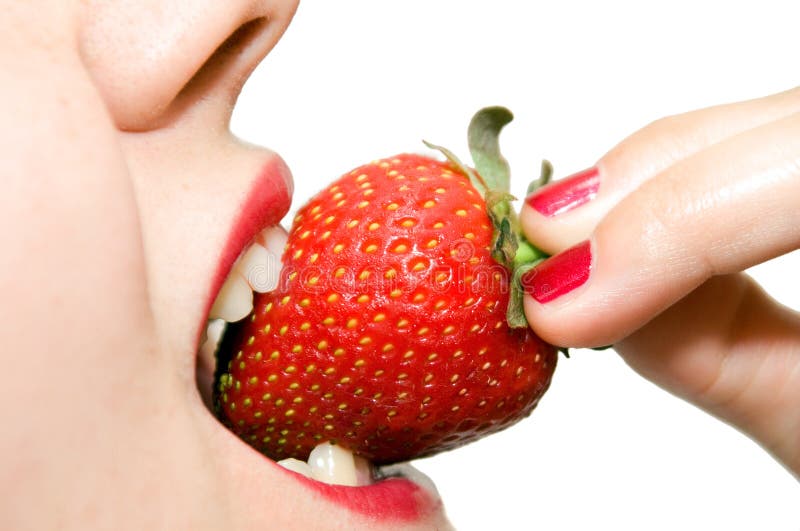 Girl eating strawberry closeup