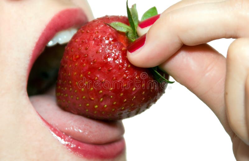 Girl eating strawberry closeup