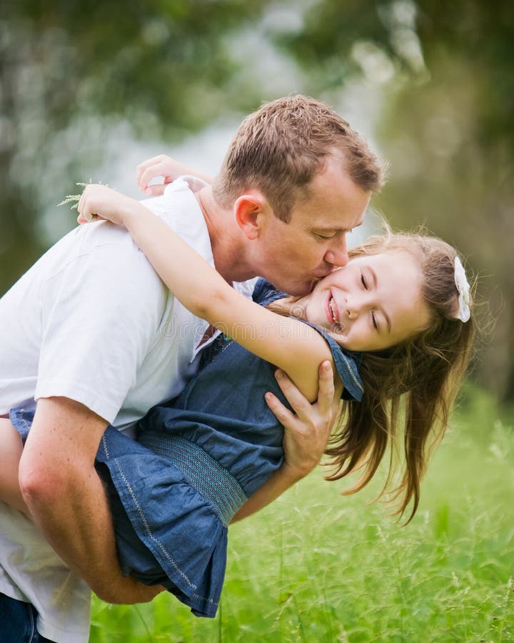 A girl enjoying a moment of fun with her dad.