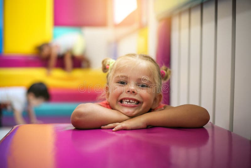 Girl enjoying in playroom. Looking at camera. Little girl in playground. Girl enjoying in playroom. Looking at camera royalty free stock photos Girl enjoying in playroom. Looking at camera. Little girl in playground. Girl enjoying in playroom. Looking at camera royalty free stock photos