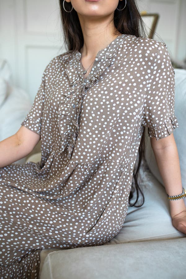 A Girl without a Face in a Coffeecolored Dress with White Dots Stock