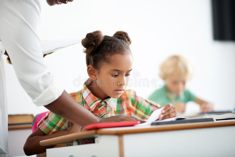 Dark-skinned girl feeling sad after seeing test results royalty free stock photography Dark-skinned girl feeling sad after seeing test results royalty free stock photography