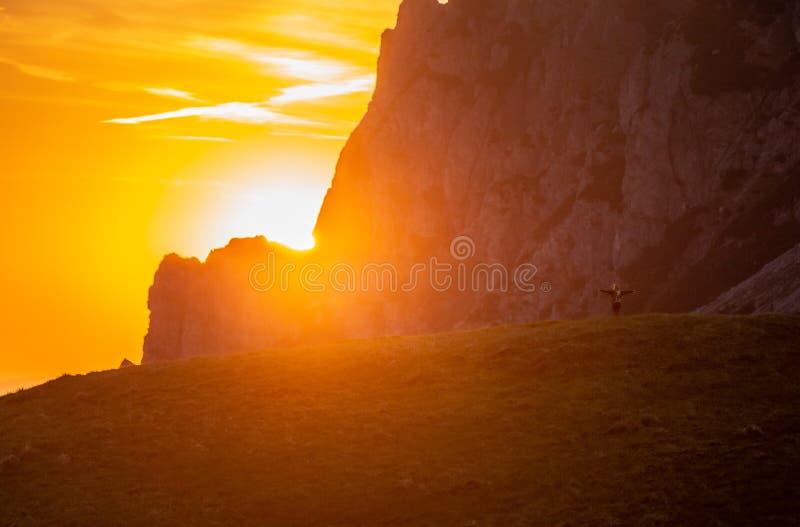 Girl female is looking on sunset in mountains and enjoy life, freedom