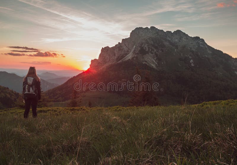 Girl female is looking on sunset in mountains and enjoy life