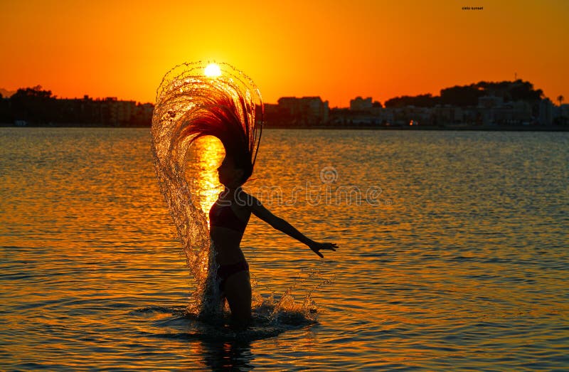 Girl flipping hair flip at sunset beach stock photography Girl flipping hair flip at sunset beach stock photography