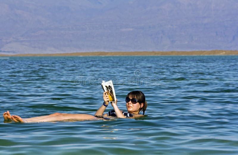 Girl floating at the Dead Sea