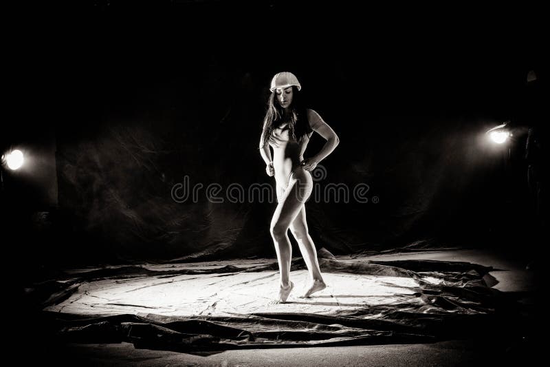The girl with the flour on the body stretches the arms up with thrown flour on black background black and white image stock image The girl with the flour on the body stretches the arms up with thrown flour on black background black and white image stock image
