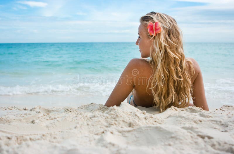 Girl with flower on the beach