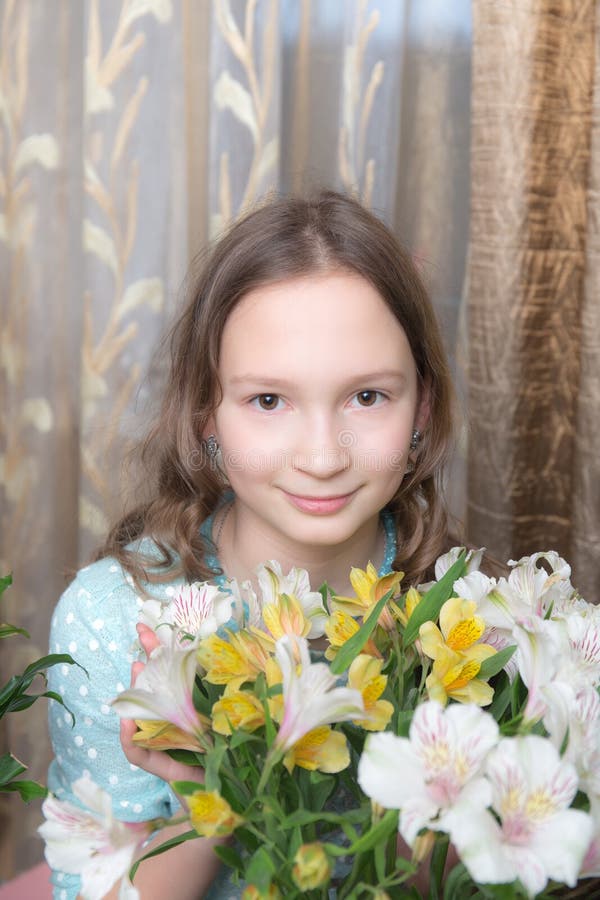 Girl with flowers at home stock image. Image of pretty 144462413