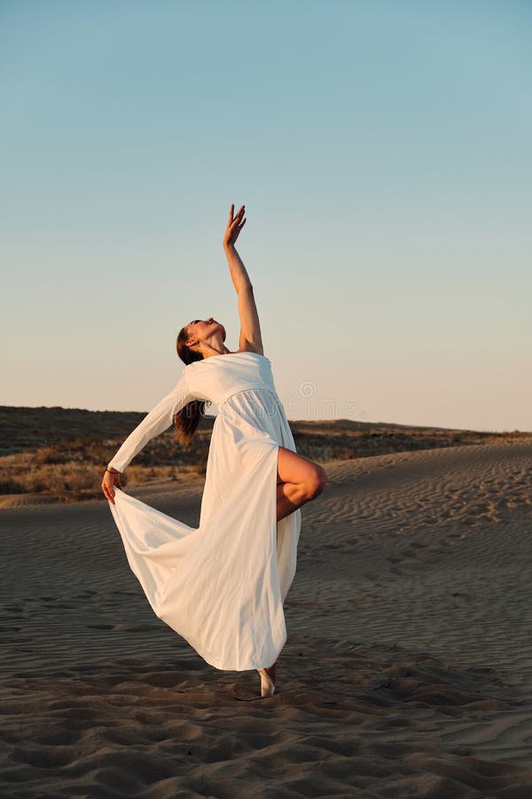 Dances in the desert in white dress