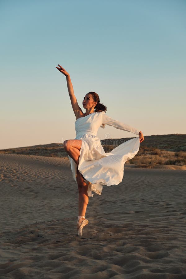 Dances in the desert in white dress