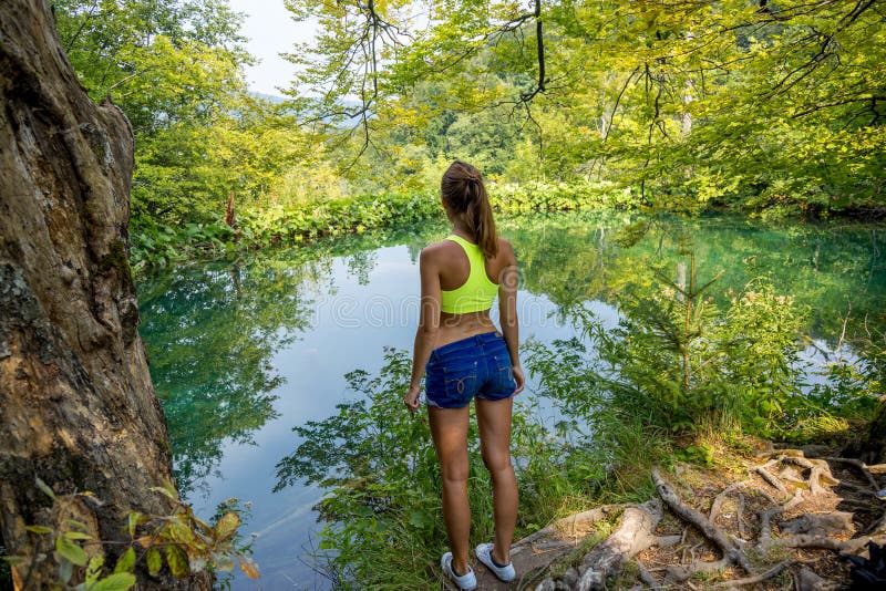 Girl by the forest lake