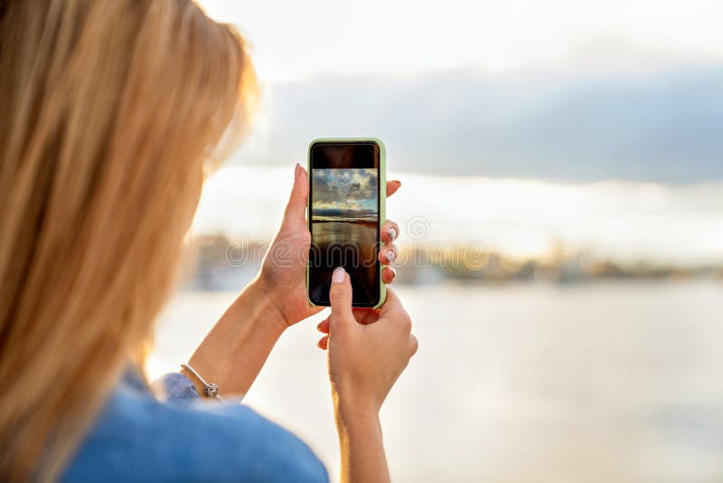 Girl freelancer at sunset speaks on the phone and works royalty free stock images Girl freelancer at sunset speaks on the phone and works royalty free stock images