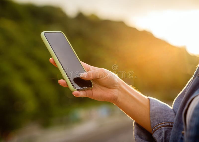 Girl freelancer at sunset speaks on the phone and works royalty free stock photo Girl freelancer at sunset speaks on the phone and works royalty free stock photo