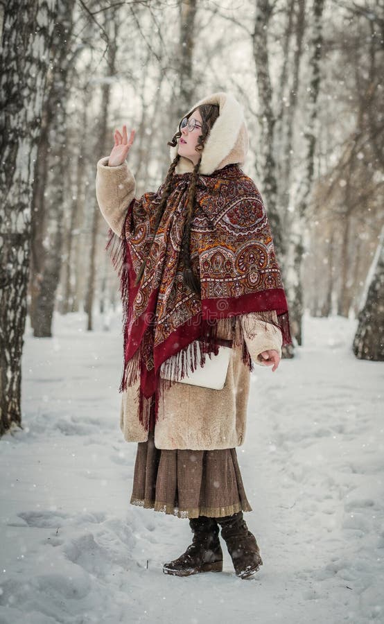 Girl in a fur coat on a walk in park and enjoying a winter day royalty free stock images Girl in a fur coat on a walk in park and enjoying a winter day royalty free stock images