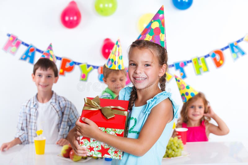 Girl with giftbox at birthday party