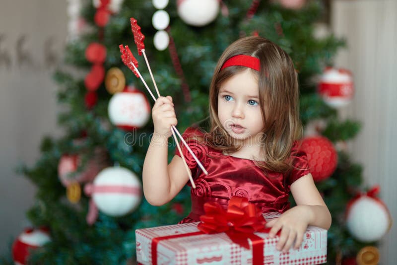 Girl with gifts near a Christmas tree