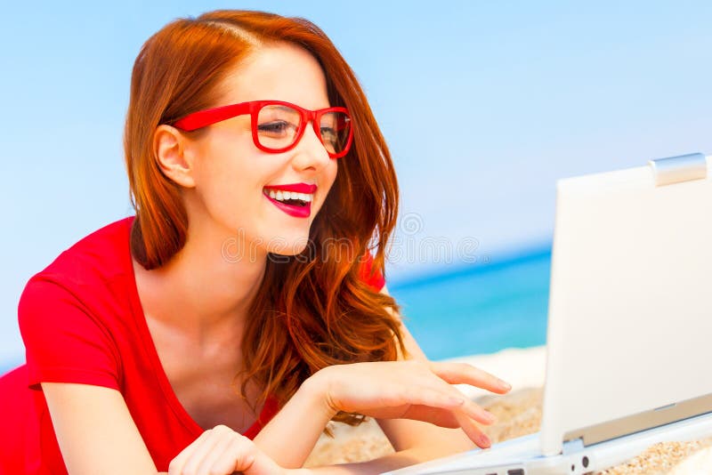 Girl in the glasses with notebook on the beach