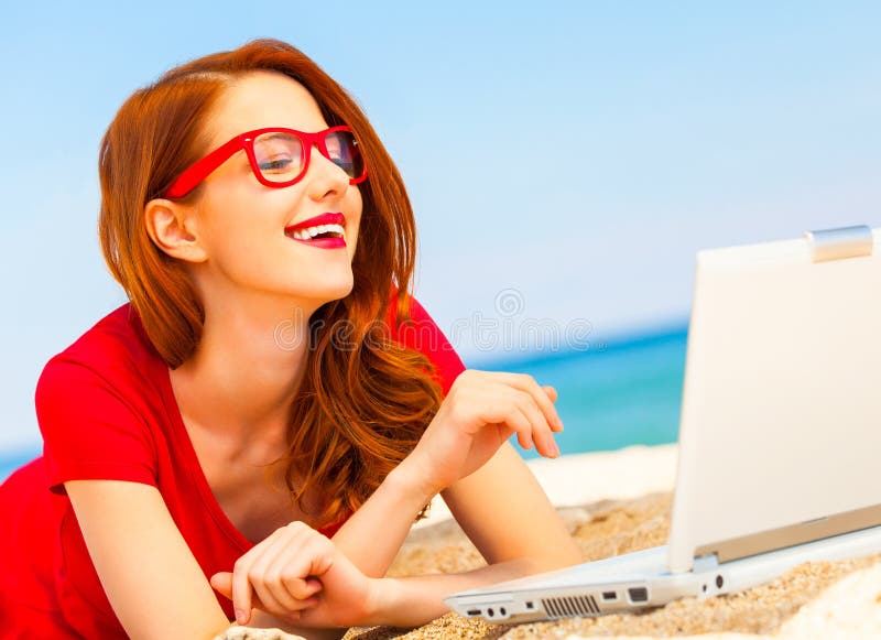 Girl in the glasses with notebook on the beach