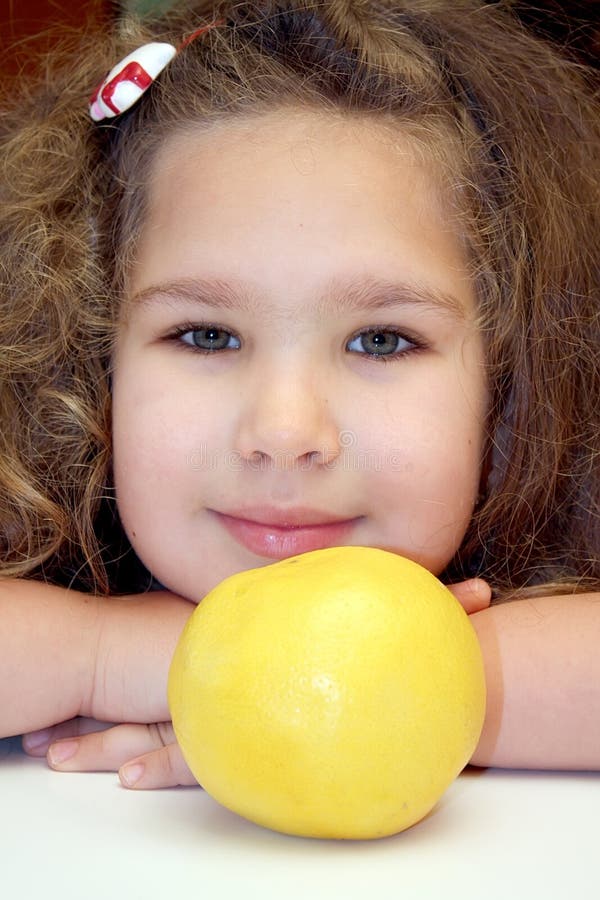 Girl and grapefruit stock image Girl and grapefruit stock image
