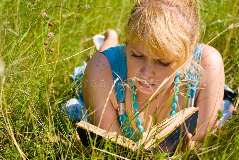 Girl in grass with book