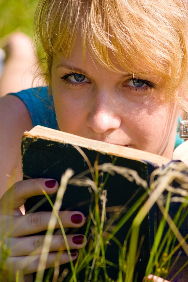 Girl in grass with book