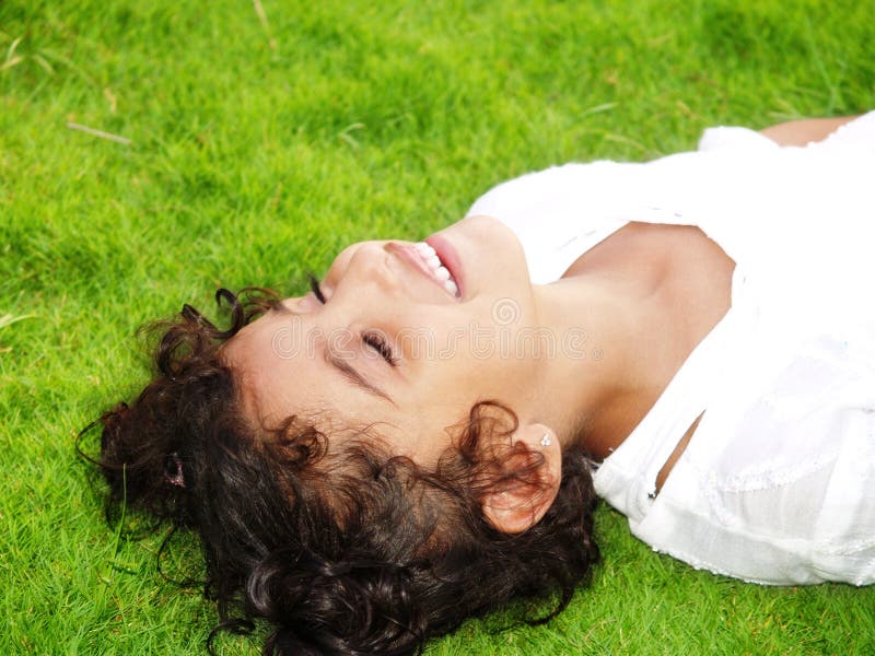 Girl on Grass with Eyes Closed