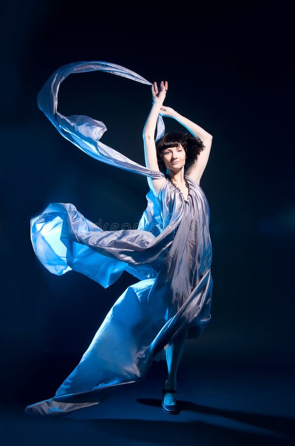 Girl in a gray dress flying with blue backlight