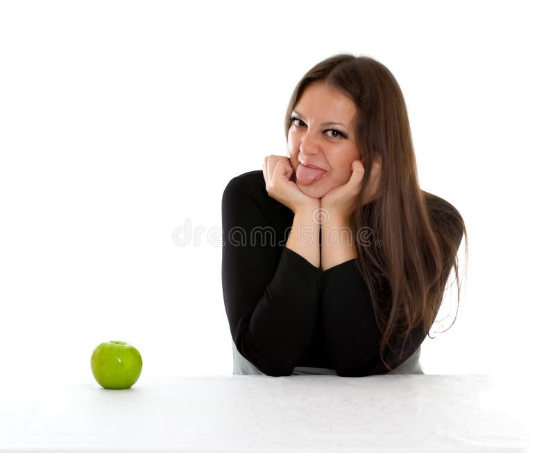 Girl with green apple showing tongue