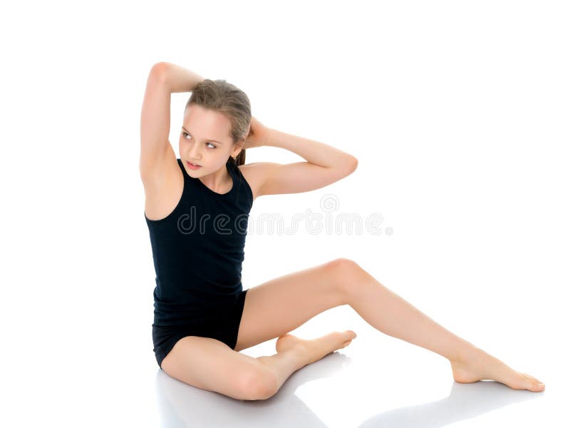 Girl gymnast in a black T-shirt and shorts prepare for the exerc royalty free stock photos