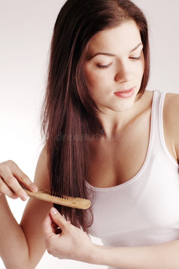 A young pretty woman with hairbrush. A young pretty woman with hairbrush