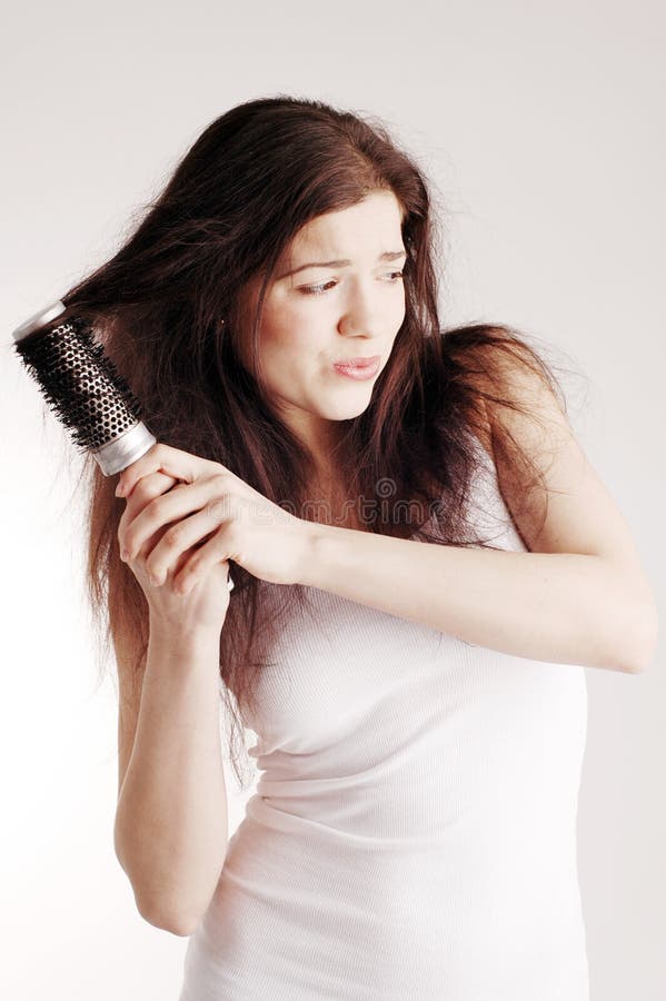 A young pretty woman with hairbrush. A young pretty woman with hairbrush