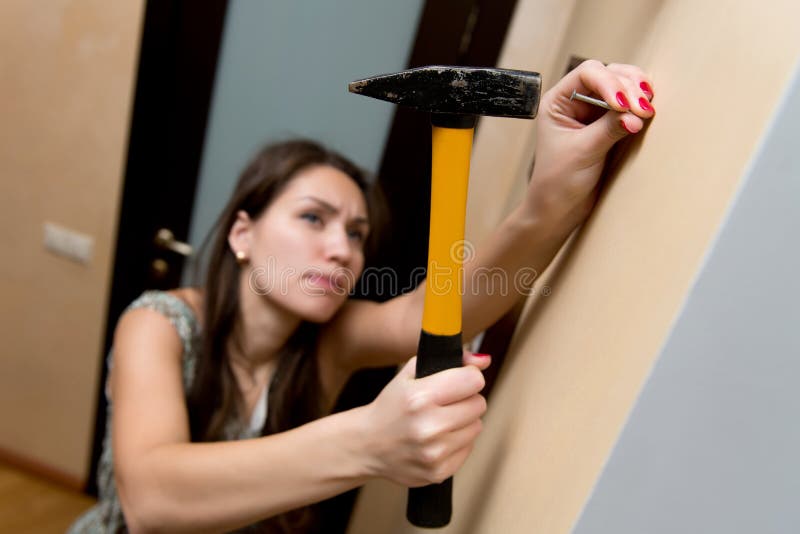 A Girl Hammer a Large Nail into the Wall with a Hammer Stock Photo - Image of manicure, feminism: 166628962 A Girl Hammer a Large Nail into the Wall with a Hammer Stock Photo - Image of manicure, feminism: 166628962