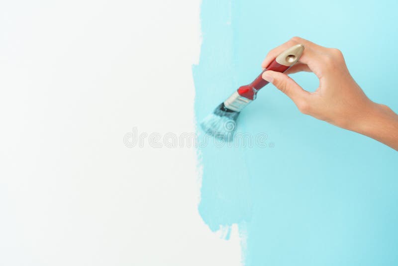 Girl hand painting wall with the paint brush Close-up, Hand of young child renovation or decorating the interior home with the. Color blue stock images Girl hand painting wall with the paint brush Close-up, Hand of young child renovation or decorating the interior home with the. Color blue stock images