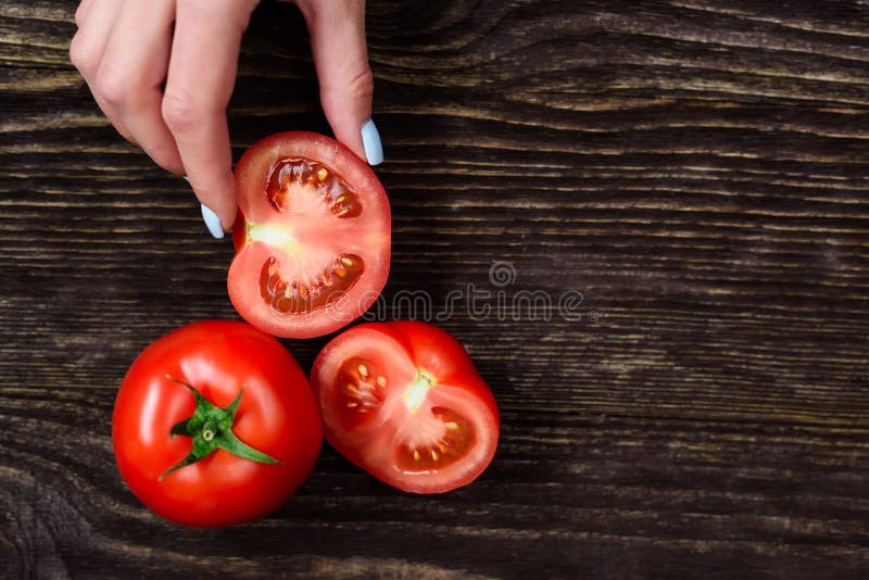 The girl in the hands holding a tomato