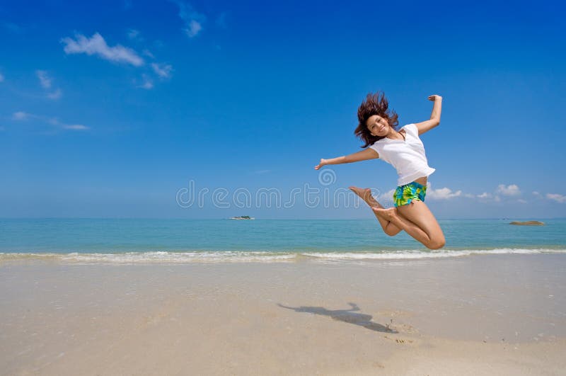 girl happy jump at the beach