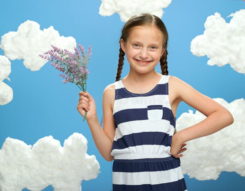 Girl Has a Lavender Flowers Bouquet in Her Hands, Dressed in Striped ...