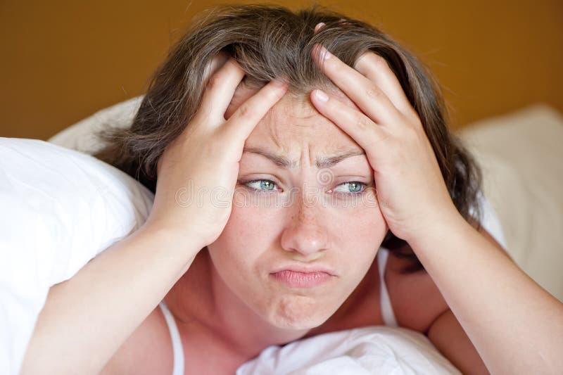 Girl has woken up in the morning in bed in a bad mood