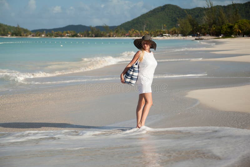 Girl with hat on the beach stock image. Image of beige 51889949