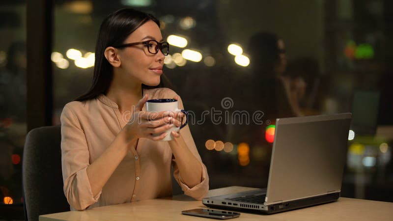 Girl having coffee while working on laptop, wireless internet in cafeteria