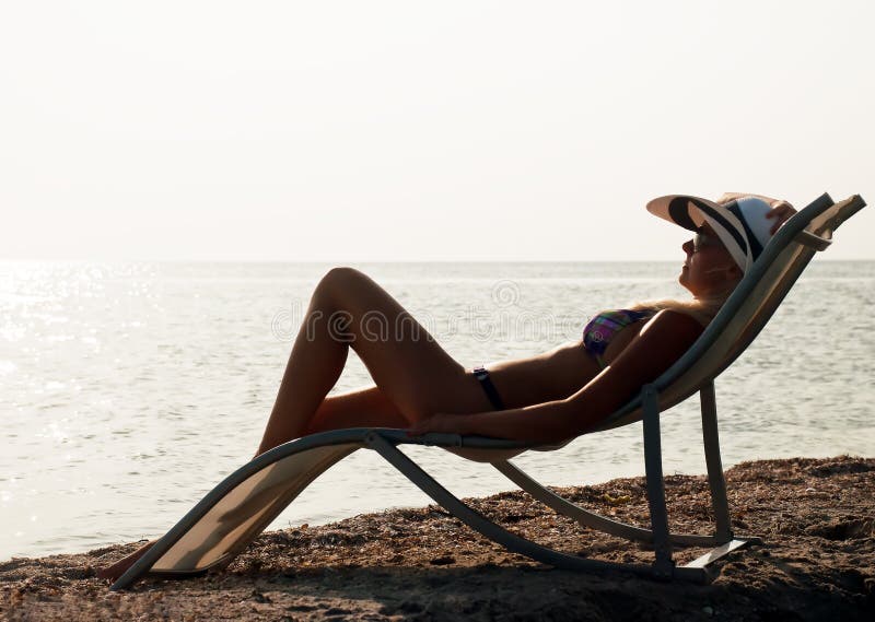 The girl having a rest on seacoast