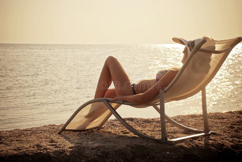 The girl having a rest on seacoast